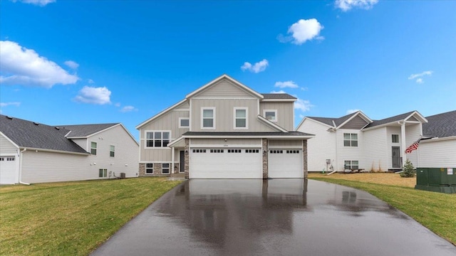 view of front of house with board and batten siding, an attached garage, driveway, and a front yard