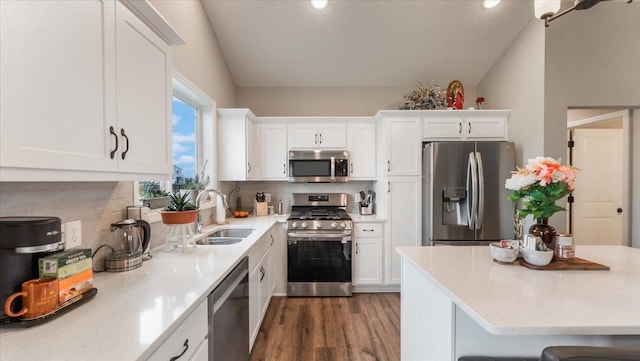 kitchen featuring light countertops, stainless steel appliances, white cabinetry, and a sink