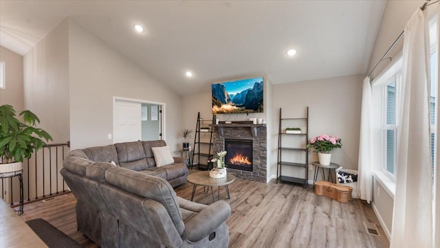 living area featuring visible vents, wood finished floors, lofted ceiling, a fireplace, and recessed lighting