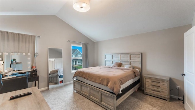 carpeted bedroom with baseboards and vaulted ceiling