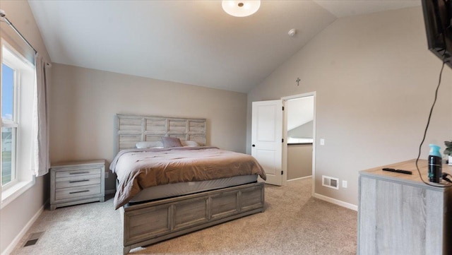 bedroom featuring light colored carpet, visible vents, and vaulted ceiling