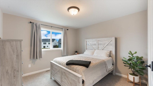 bedroom featuring baseboards and light colored carpet