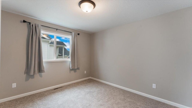 unfurnished room with carpet floors and baseboards