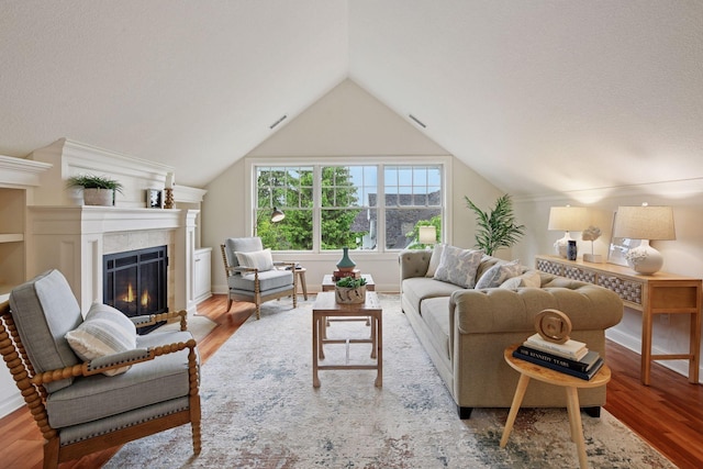 205 Mill St Unit S301, Excelsior, MN 55331 - living area with wood finished floors, a fireplace with flush hearth, vaulted ceiling, and baseboards