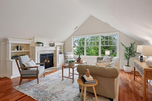 205 Mill St Unit S301, Excelsior, MN 55331 - living room with wood finished floors, a warm lit fireplace, lofted ceiling, and baseboards