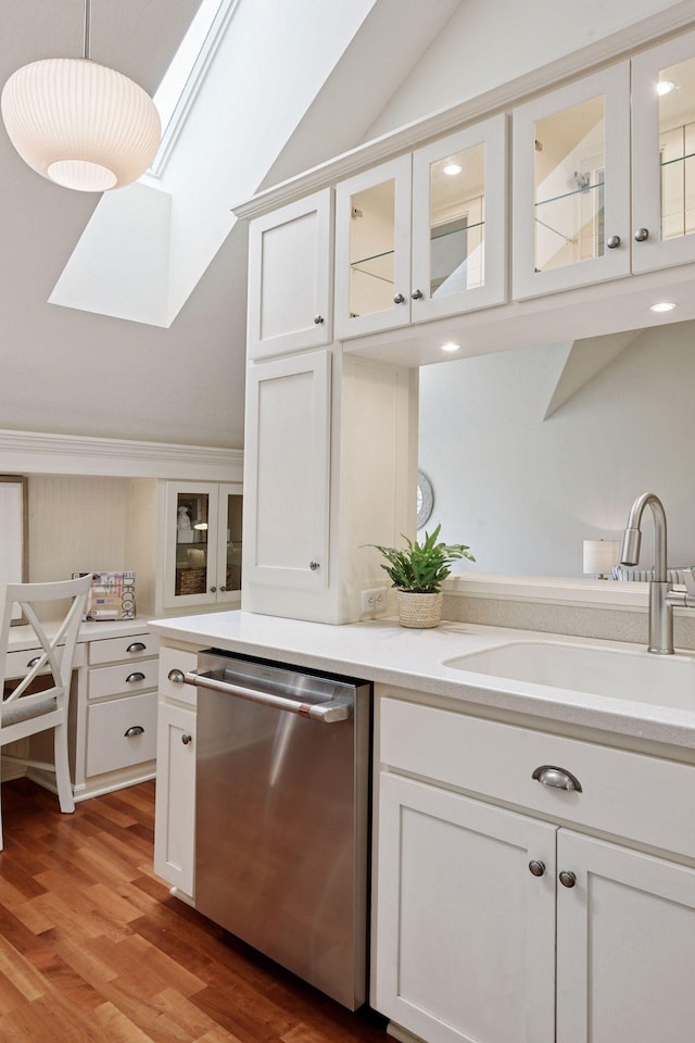 205 Mill St Unit S301, Excelsior, MN 55331 - kitchen with stainless steel dishwasher, light wood finished floors, a sink, vaulted ceiling, and white cabinetry