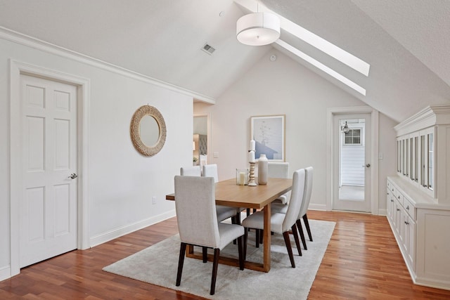205 Mill St Unit S301, Excelsior, MN 55331 - dining space with a skylight, light wood finished floors, lofted ceiling, and baseboards