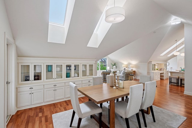 205 Mill St Unit S301, Excelsior, MN 55331 - dining space featuring a skylight, light wood finished floors, and lofted ceiling