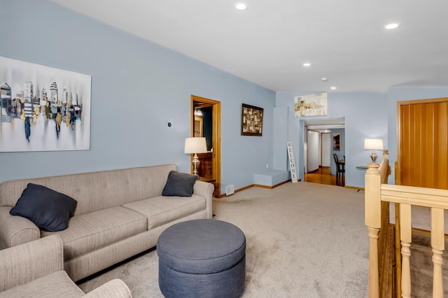 living room with baseboards, recessed lighting, and carpet