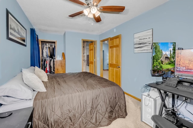 bedroom featuring ceiling fan, baseboards, carpet flooring, and a closet