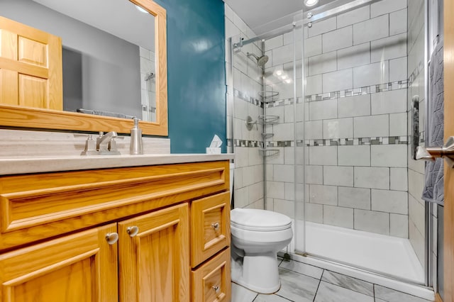 full bath featuring toilet, a stall shower, and vanity