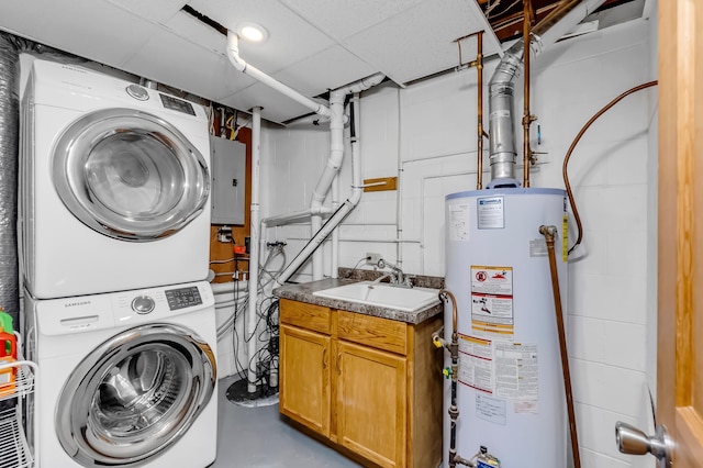 washroom featuring stacked washer / drying machine, cabinet space, gas water heater, electric panel, and a sink