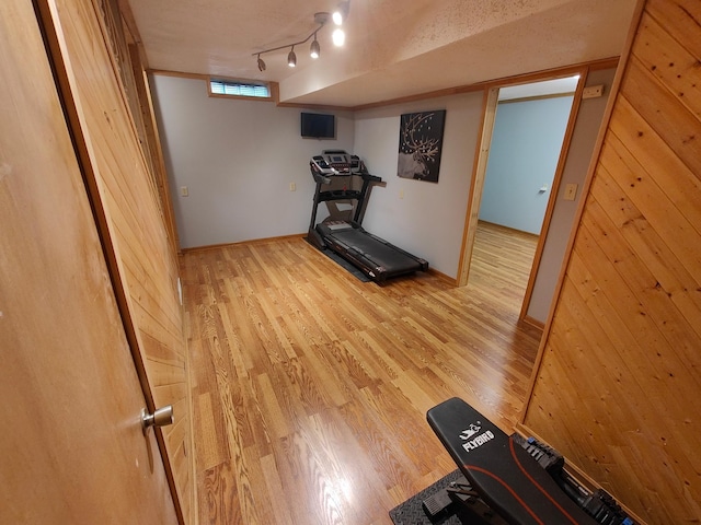 1270 46th Ave NE, Columbia Heights, MN 55421 - workout area featuring light wood-style floors, wooden walls, baseboards, and track lighting