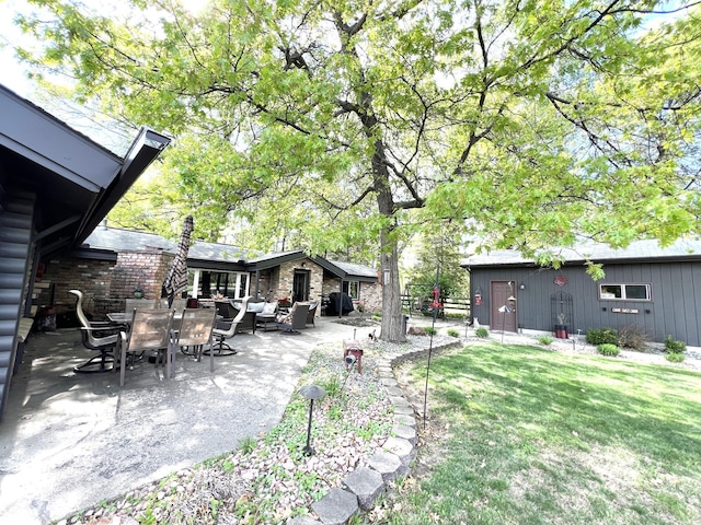 view of green lawn featuring outdoor lounge area and a patio