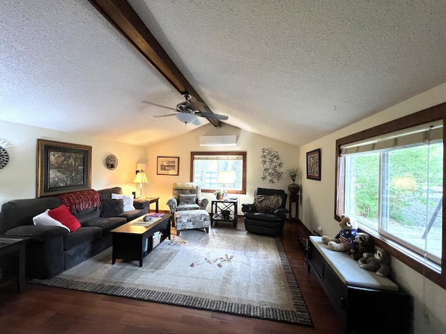 living area with a textured ceiling, wood finished floors, plenty of natural light, a wall mounted AC, and a ceiling fan