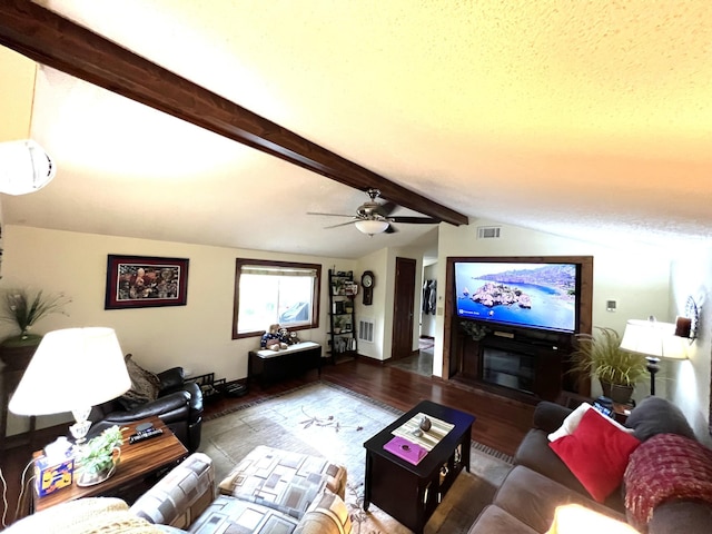 living area featuring wood finished floors, a ceiling fan, and baseboards