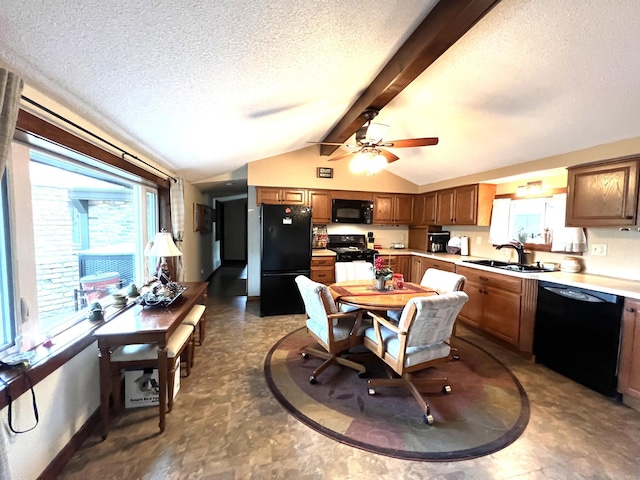 kitchen featuring black appliances, a sink, a textured ceiling, ceiling fan, and light countertops