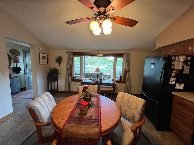 carpeted dining space with lofted ceiling and ceiling fan