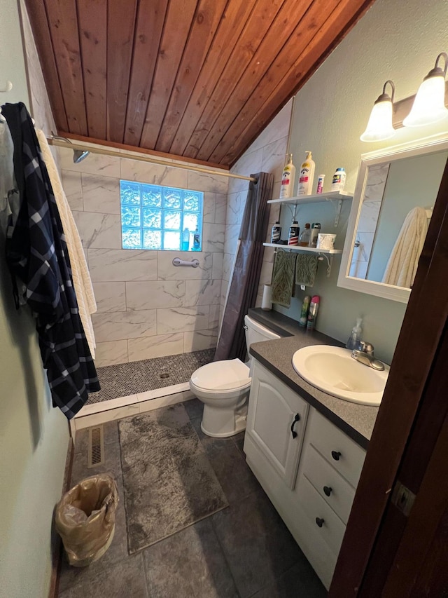 full bath featuring tiled shower, wood ceiling, vanity, toilet, and lofted ceiling
