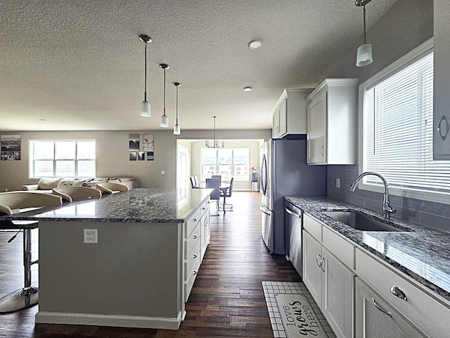 2505 Jaber Ave NE, Saint Michael, MN 55376 - kitchen featuring a sink, dishwasher, dark wood-style flooring, healthy amount of natural light, and a textured ceiling