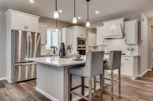 2505 Jaber Ave NE, Saint Michael, MN 55376 - kitchen featuring stainless steel appliances, wood finished floors, white cabinetry, and recessed lighting