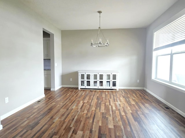 2505 Jaber Ave NE, Saint Michael, MN 55376 - unfurnished dining area with a chandelier, wood finished floors, and baseboards