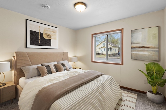 bedroom with baseboards and carpet flooring