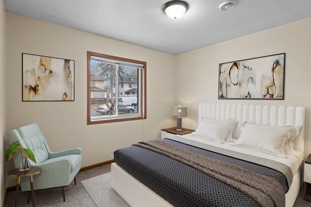 bedroom featuring carpet and baseboards