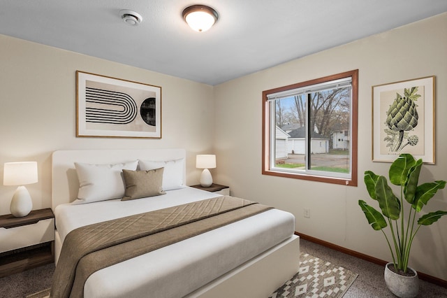bedroom featuring light colored carpet and baseboards