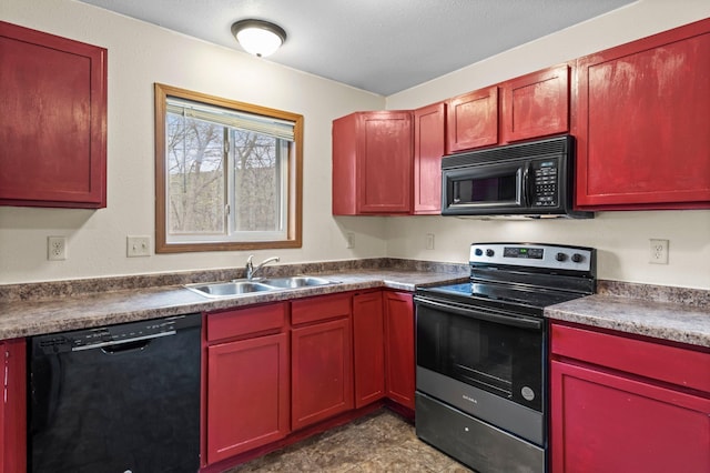 kitchen featuring black appliances, reddish brown cabinets, and a sink