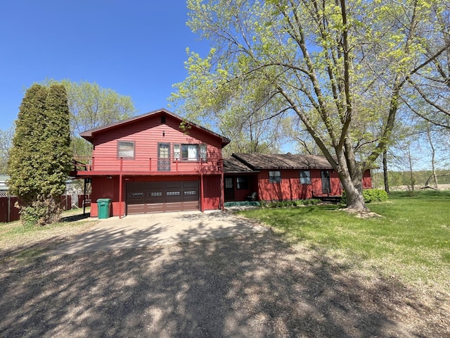 10151 US Highway 169, Garrison, MN 56450 - view of front of house featuring asphalt driveway, a garage, and a front lawn