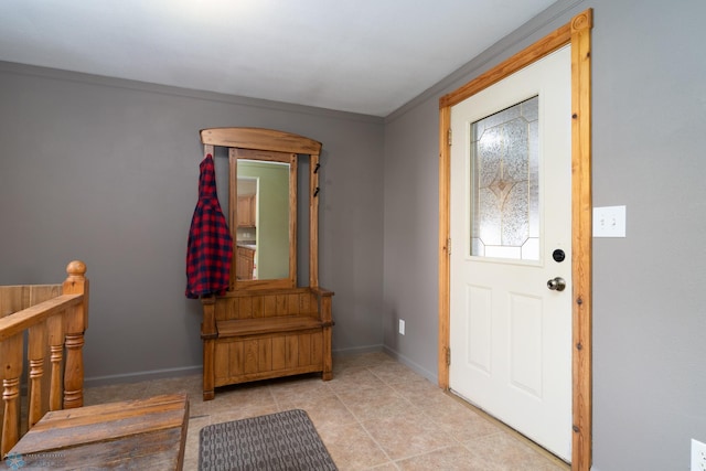 entrance foyer with crown molding and baseboards