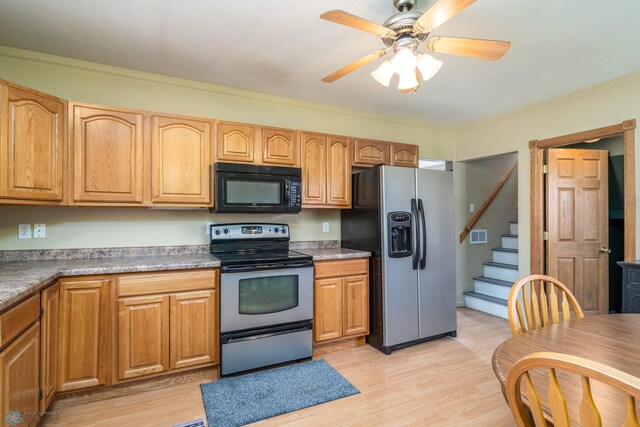 kitchen with a ceiling fan, stainless steel appliances, and light wood-style floors