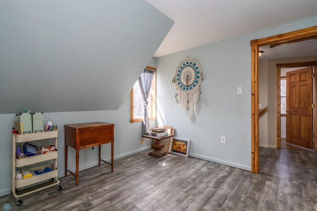 bonus room with plenty of natural light, wood finished floors, and baseboards