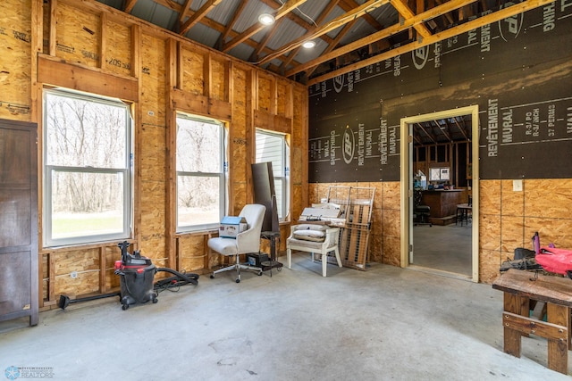 miscellaneous room featuring a wealth of natural light and unfinished concrete flooring