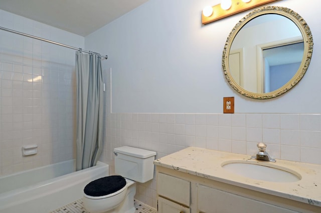 bathroom featuring shower / bath combo with shower curtain, tile patterned flooring, vanity, toilet, and tile walls