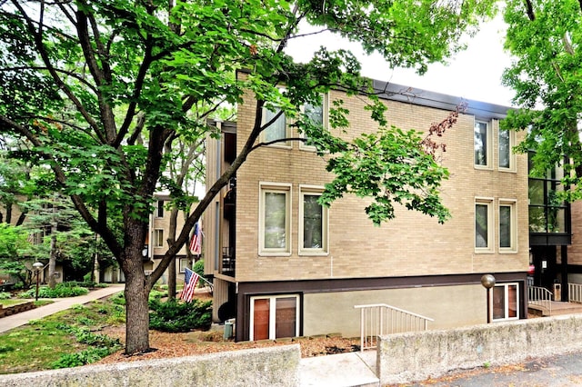 view of side of property featuring brick siding