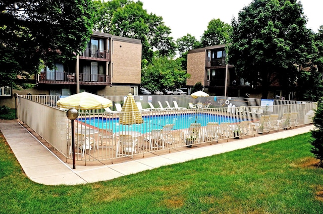pool with a lawn and fence