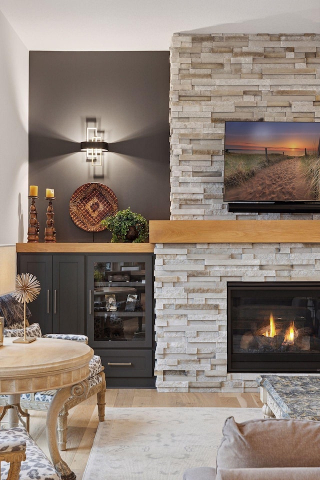 living area with wood finished floors and a fireplace
