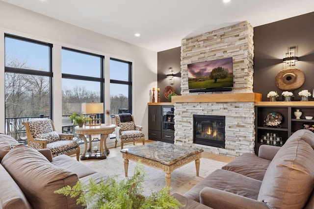 living area with wood finished floors, a fireplace, and recessed lighting