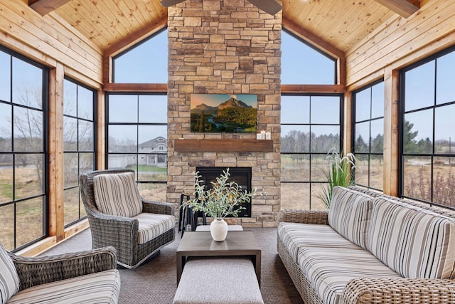 sunroom with carpet flooring, beam ceiling, high vaulted ceiling, and wooden ceiling