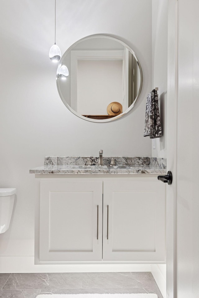 half bath featuring toilet and vanity