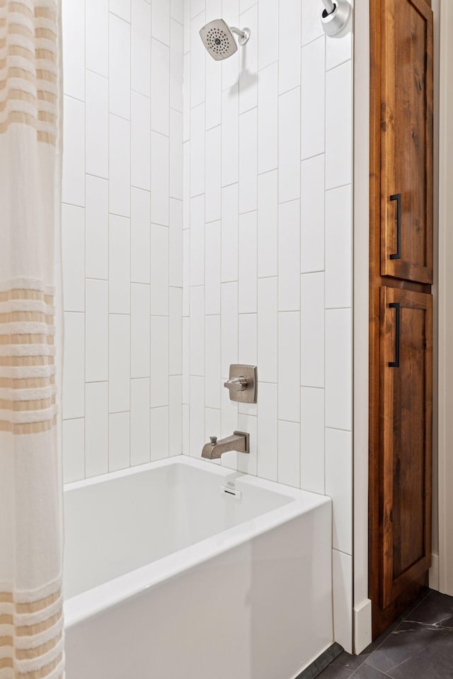 full bathroom with tile walls and shower / bath combo