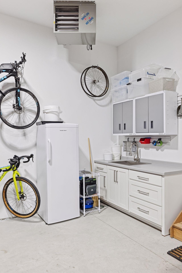 clothes washing area with a sink and a heating unit