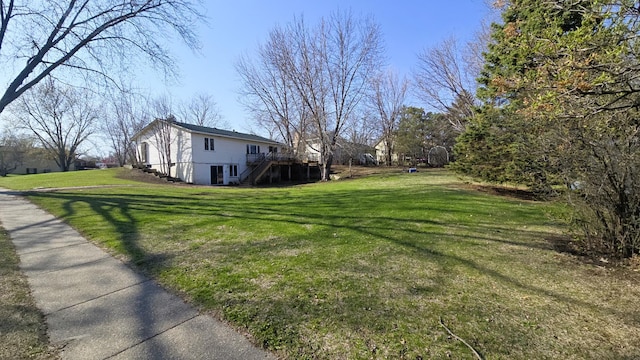 view of yard with a wooden deck and stairs