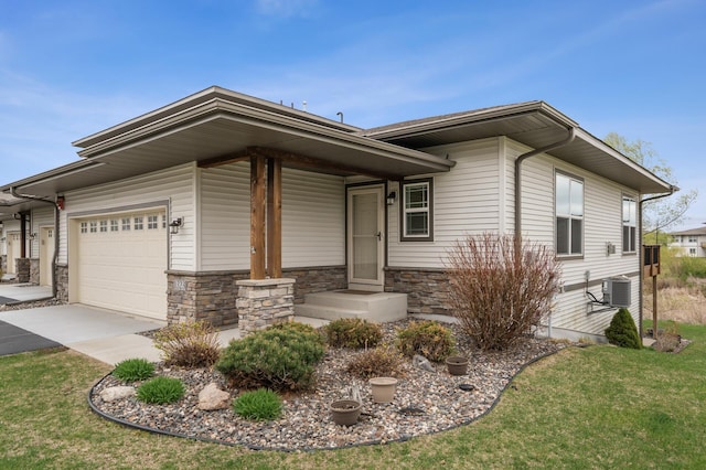 view of front facade with stone siding, concrete driveway, a garage, a front yard, and central AC unit