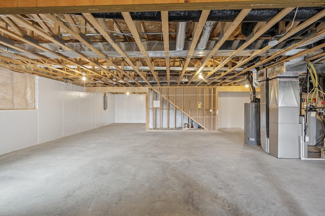 unfinished basement with gas water heater and heating unit