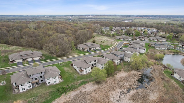 bird's eye view with a wooded view and a residential view
