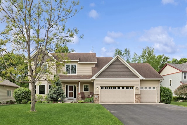 813 Quie Ln, Northfield, MN 55057 - craftsman-style house featuring a garage, driveway, a front yard, and a shingled roof