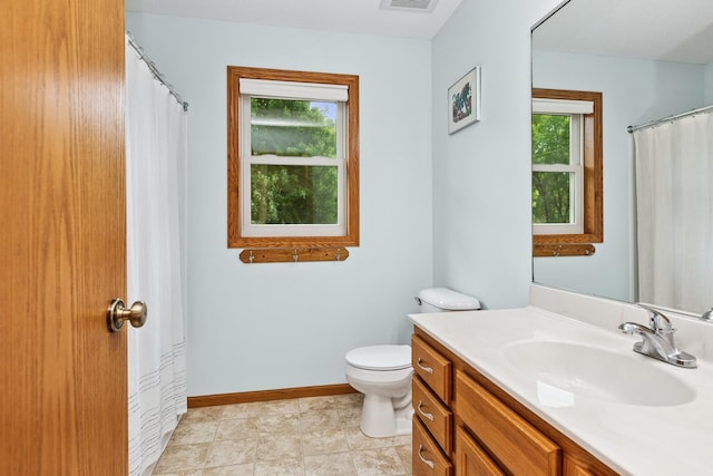 813 Quie Ln, Northfield, MN 55057 - bathroom with toilet, vanity, and baseboards